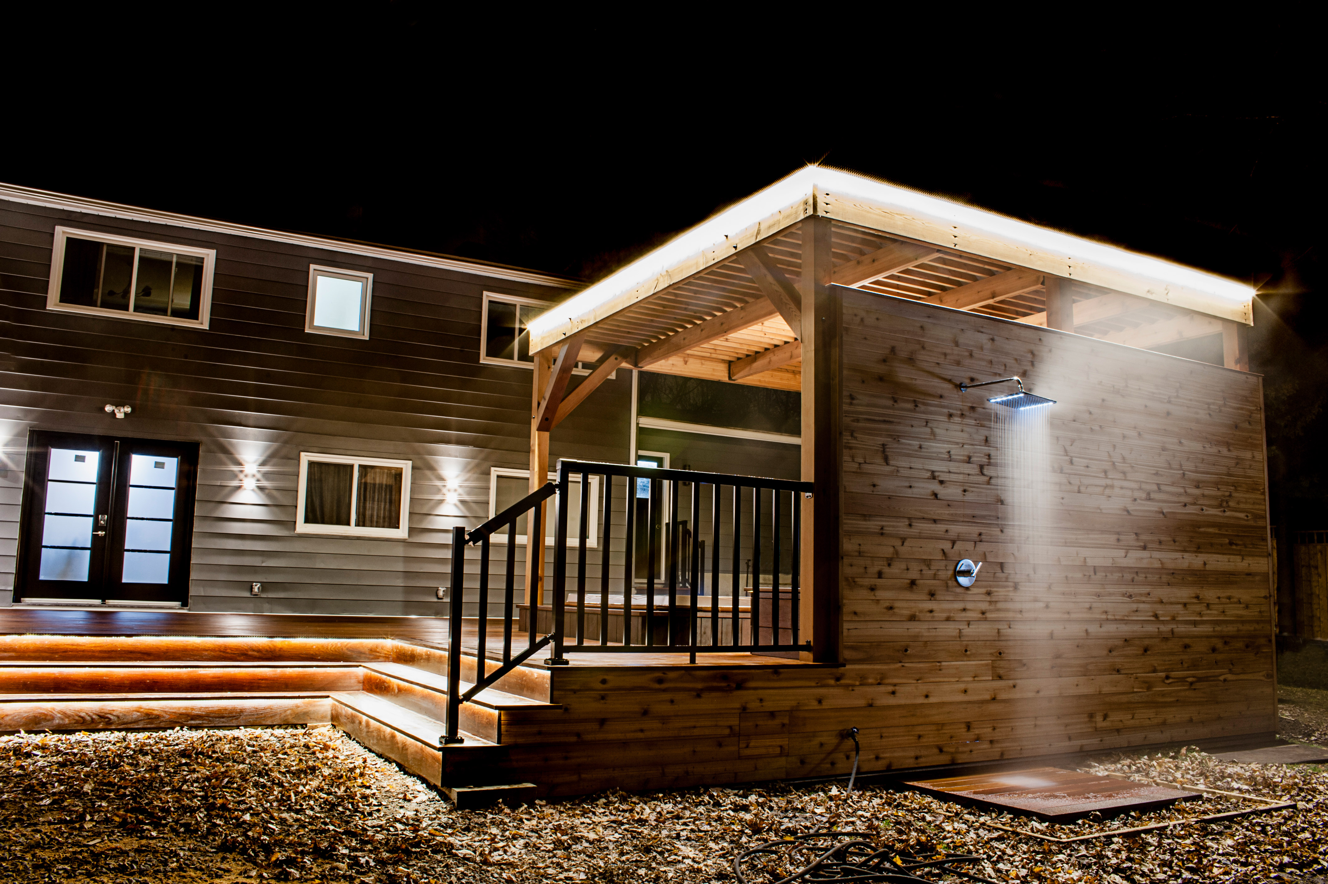 four season tv outdoor kitchen eating area shower hottub hot tub backyard fantasy dream contractor renovation builder build builders ottawa luxury wood rustic modern light show